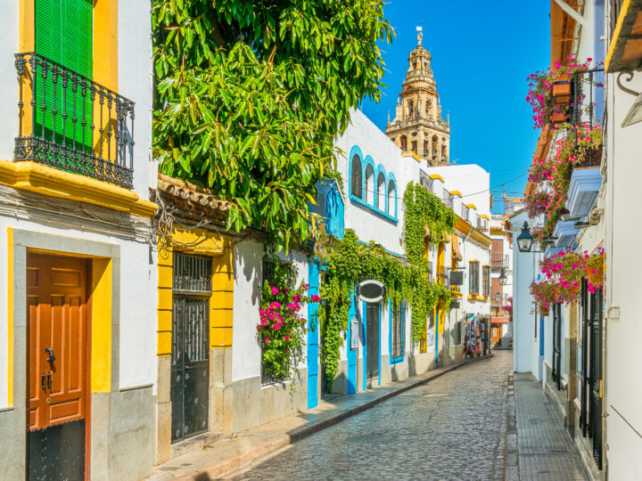 Scenic sight in the picturesque Cordoba jewish quarter with the bell tower of the Mosque Cathedral. Andalusia, Spain.