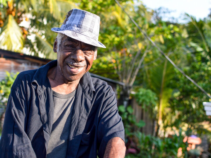 Garifuna man smiles into the camera in Livingston, Guatemala